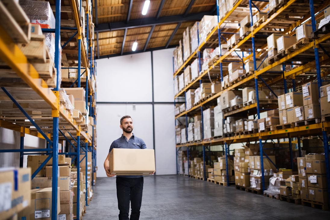 Male Warehouse Worker with a Large Box